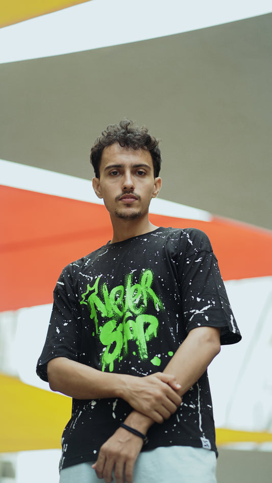 "NEVER STOP" Oversized Streetwear T-Shirt – All-Over Splatter Print (Black)