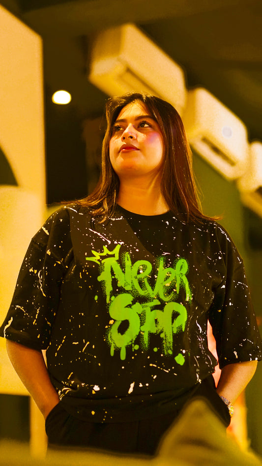 "NEVER STOP" Oversized Streetwear T-Shirt – All-Over Splatter Print (Black)