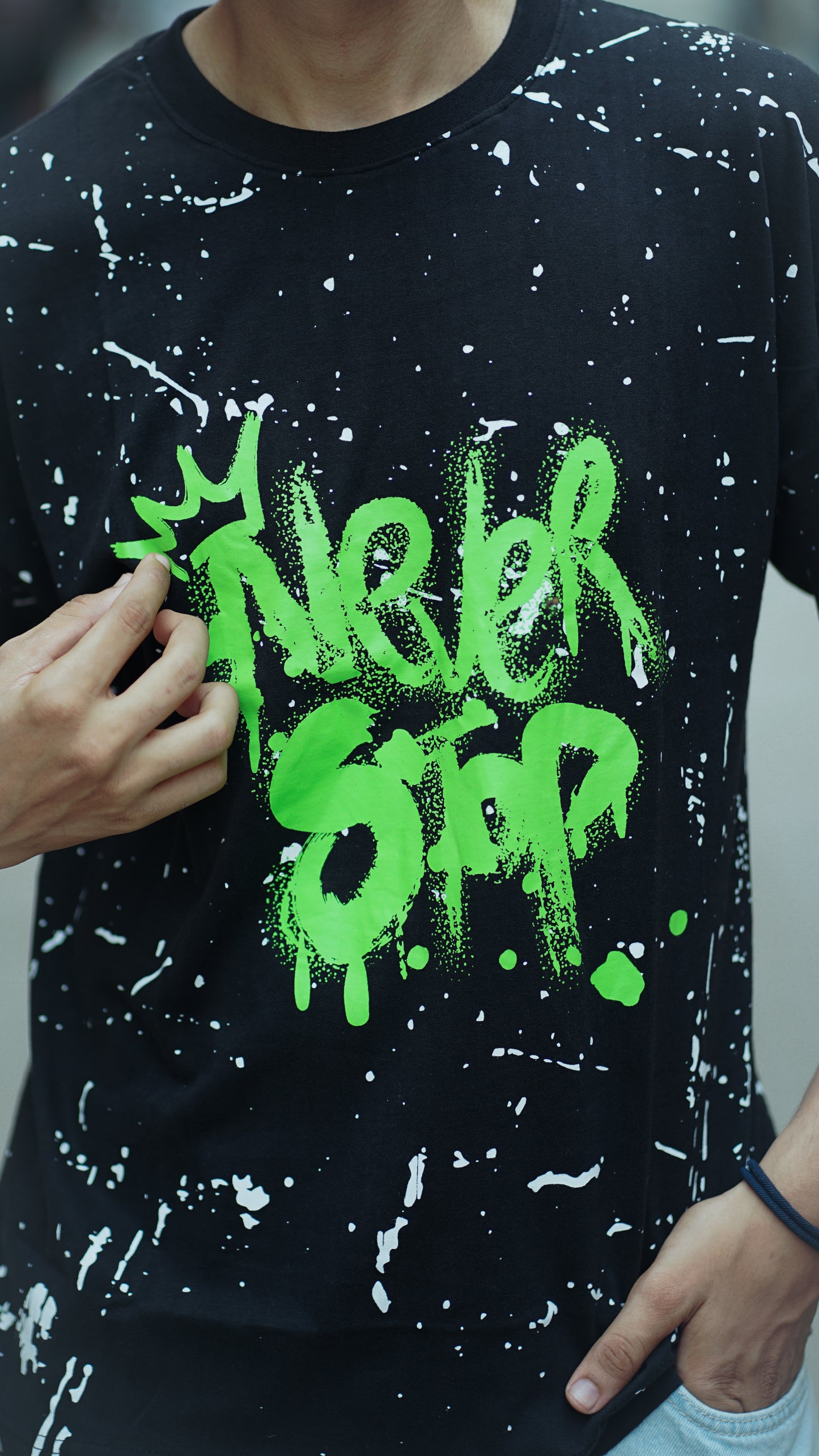 "NEVER STOP" Oversized Streetwear T-Shirt – All-Over Splatter Print (Black)